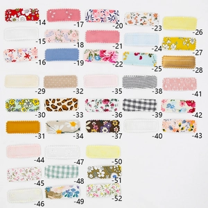 Detail view of square BB hair clips set featuring multiple floral embroidery patterns