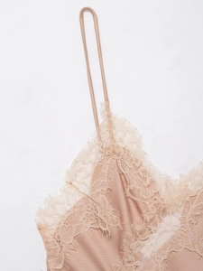 Detailed close-up of champagne satin camisole featuring delicate eyelash lace trim