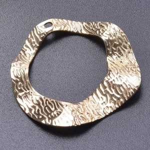 Macro shot of gold-plated stainless steel textured geometric DIY jewelry connector