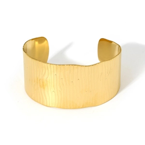 Minimalist wide gold cuff bracelet for women featuring textured water ripple patterns