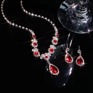 Detailed macro shot of bridal jewelry set with ruby red rhinestones and silver alloy base