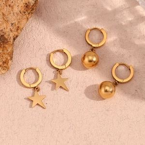 Detail of 18K gold plated stainless steel hoop earrings with star and bead charms