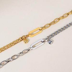 Luxury gold and silver curb chain bracelet with heart pendant and OT buckle design