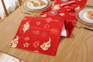 Close-up of red festive table runner with golden traditional Chinese clouds and lanterns