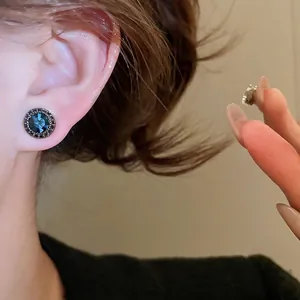 Vintage silver needle stud earrings with round dark blue stone and black accents