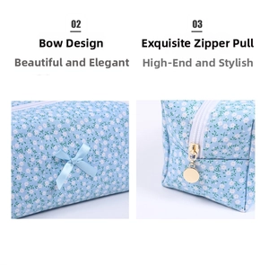 Detail of floral makeup bag featuring a blue bow and round gold zipper puller