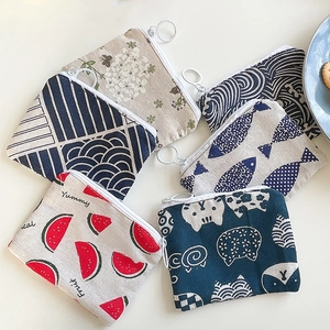 Flat lay of small cotton floral coin purses with cute patterns and round metal zippers