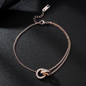 Macro detail of rose gold double interlocking rings with crystals and Roman numerals