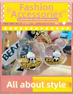 Détail d'un porte-clés panda avec paillettes mobiles dorées et dragonne en silicone bear