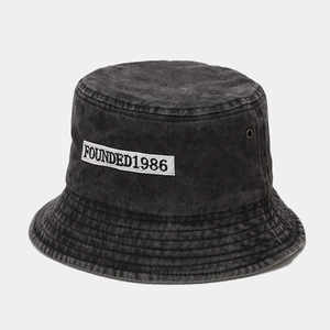 Detail of washed denim bucket hat with FOUNDED1986 embroidery and metal eyelets
