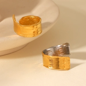 Macro detail of 18K gold plated stainless steel ring with textured lava hammer finish