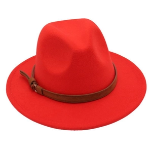 Detailed view of red wide brim fedora hat featuring a brown leather belt buckle strap