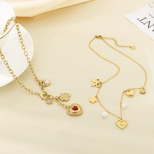 Gold necklace set featuring red heart pendant, bow, pearls and zircon star accents