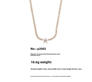 Detail view of gold star pendant with zircon pavé setting on titanium steel tennis chain