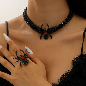 Gothic black spider jewelry set with red gems on beaded necklace and ring worn by model
