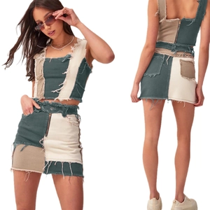 Two-piece denim set with cropped vest and high-waisted mini skirt featuring frayed edges