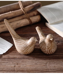 Close-up of resin bird ornaments featuring detailed white spiral wood grain textures