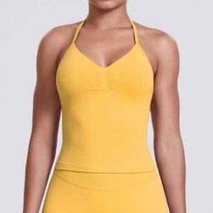 Detailed close-up of yellow seamless yoga top with halter neck and ribbed hem
