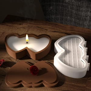 Detailed view of heart-shaped silicone mold and finished candle on a wooden table