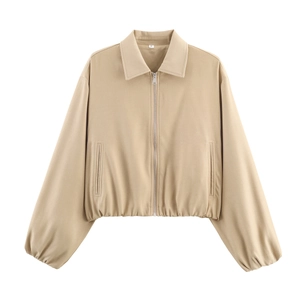 Close-up detail of khaki peplum bomber jacket zipper and smooth fabric texture