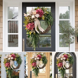 Detail of floral farmhouse wreath with pink flowers and burlap bow on various entry doors