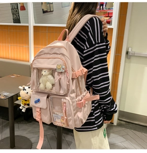 Zaino scuola rosa con multitasche, scomparto trasparente e graziosi ciondoli
