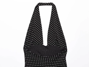 Detail of the halter neckline and polka dot pattern on the vintage black dress