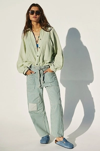 Detail of blue and white striped patchwork cargo pants with drawstring and side pockets