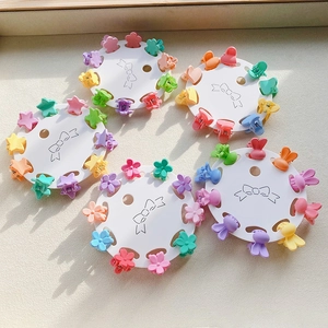 Macro view of mini colorful matte flower and star hair clips set on display card