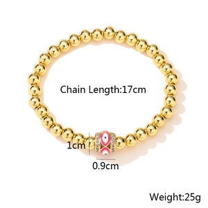 Detailed view of 18K gold bead bracelet with evil eye pendant and measurement specs