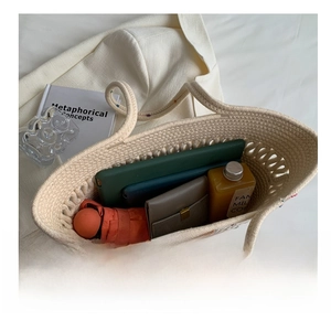 Spacious interior of a beige woven tote bag holding a tablet, umbrella, and essentials