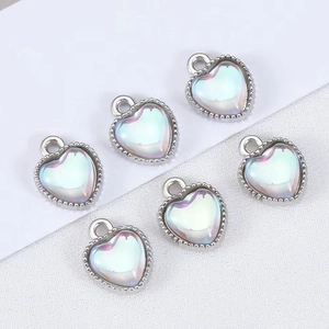 Macro shot of 6 heart-shaped pendants with silver metal frames and pearlescent finish