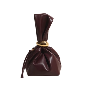Elegant dark red-brown bucket bag with gold metal ring and sleek pleated leather