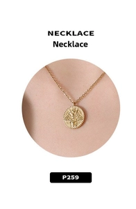 Macro detail of 18k gold plated coin pendant featuring an embossed bee design
