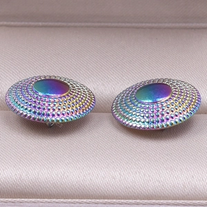 Macro view of rainbow-colored 304 stainless steel earrings with dot texture and oil slick finish
