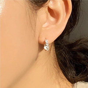 S925 sterling silver hoop earrings with sparkling cubic zirconia on female model