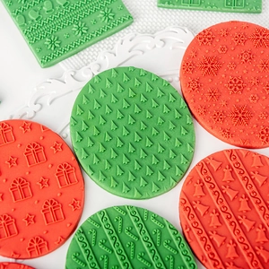 Christmas snowflake and tree cookie cutters embossing dough on white table surface