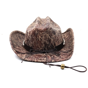 Close-up of distressed suede texture and black leather band on brown western cowboy hat
