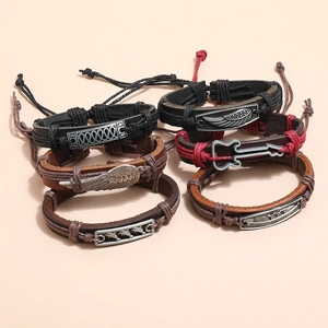 Vintage 5-piece set of woven leather bracelets featuring metal wing and guitar pendants