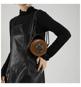Gothic brown leather mini bag with 3D silver skull and metal chain worn by a model