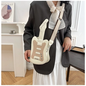 Detail of guitar-shaped crossbody bag with star rivets and adjustable fabric strap