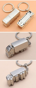 Three-angle views of a polished silver metal truck-shaped keychain with shiny finish