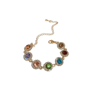 Bracelet vintage doré orné de sept pierres colorées entourées de diamants scintillants
