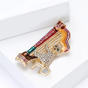 Detailed macro view of creative cat harp brooch with colorful rhinestones and enamel