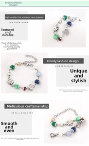Detail of 316L stainless steel bracelet with daisy charms, colorful beads, and dice elements