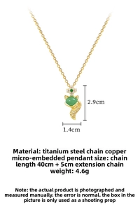 Detailed size view of fox pendant with green gemstone and cubic zirconia in gold