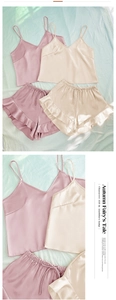 Detail of satin pajama set with V-neck camisole and ruffled hem shorts in champagne color