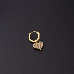 Macro shot of gold heart huggie earring with shimmering micro-paved cubic zirconia stones