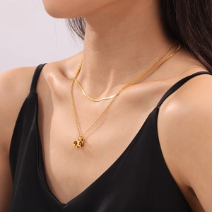 Layered gold titanium necklace with minimalist pony pendant on double strand chains