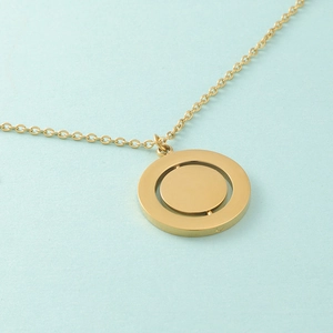 Detailed macro view of the inner rotating gold geometric pendant on a delicate chain